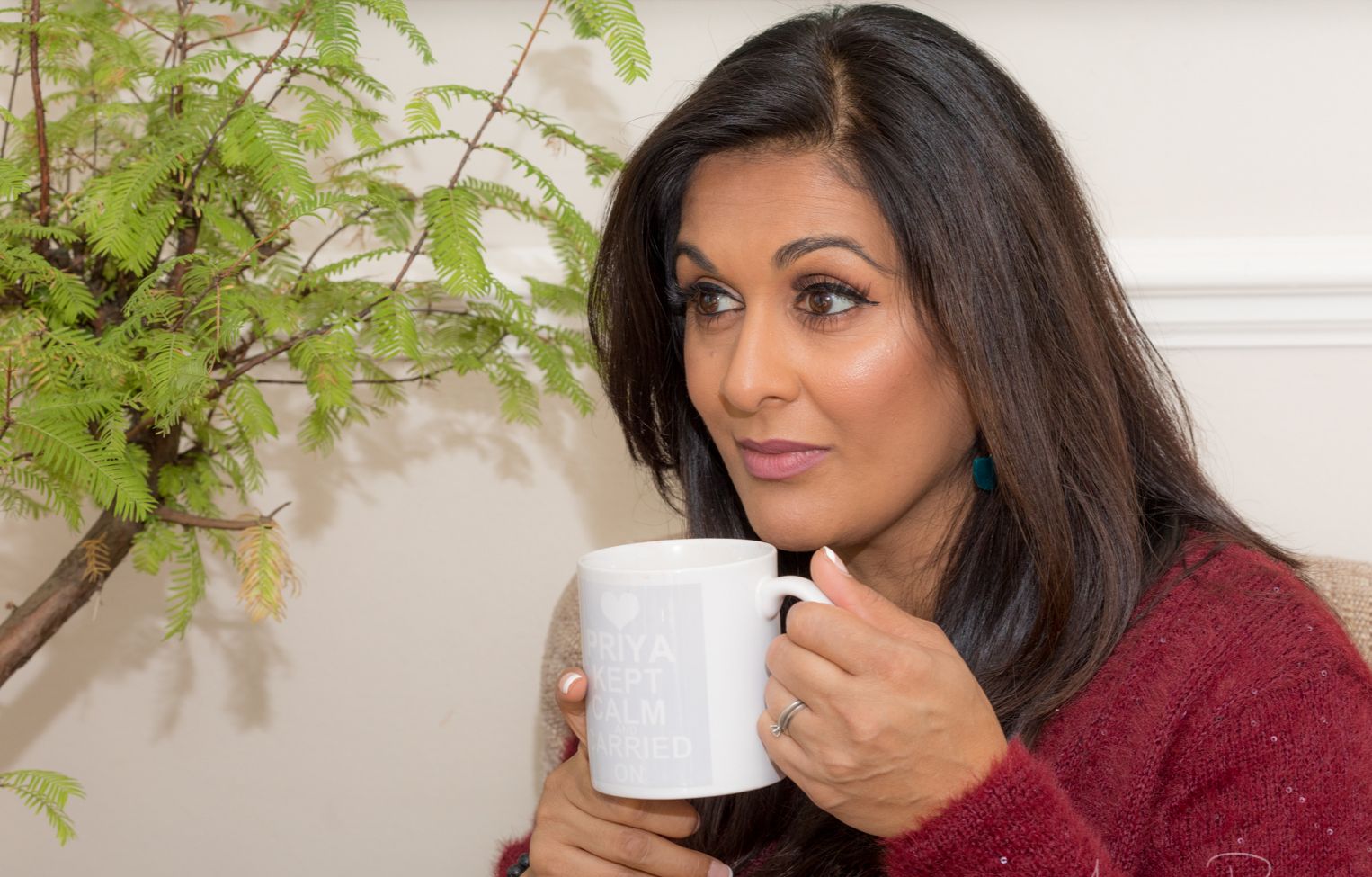 Priya Khan holding a mug of tea